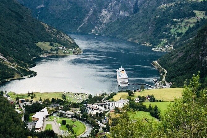 A cruise ship at anchor below the cliffs of Geirangerfjord
